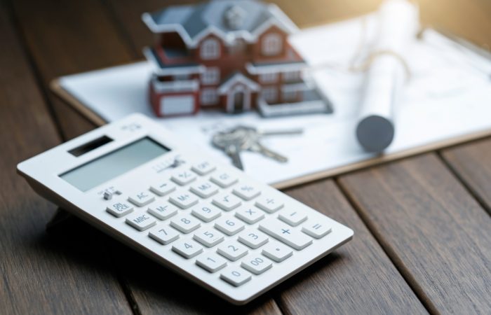 calculator-front-villa-house-model-with-blueprint